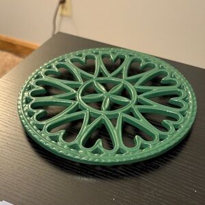 Vintage green enamel sunburst cast iron hotplate/trivet